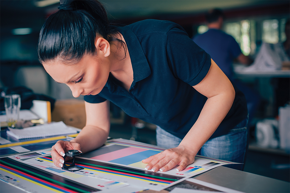 Graphic Designer looking at CMYK values